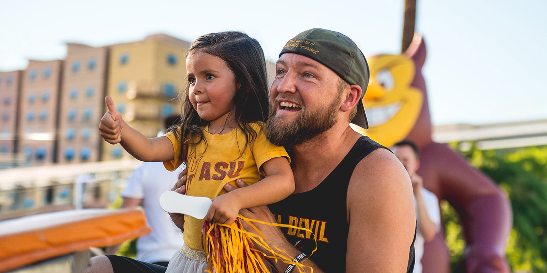 An ASU alumni with their child.